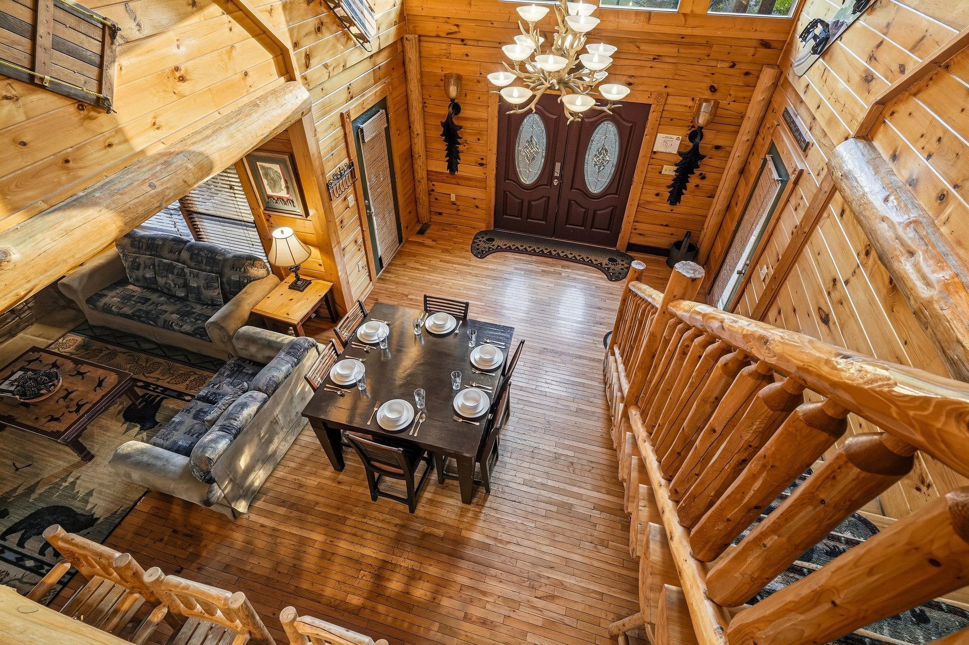 Soaring cathedral ceilings frame your cozy cabin retreat, where warm wood beams embrace an open living and dining space perfect for gathering after mountain adventures.