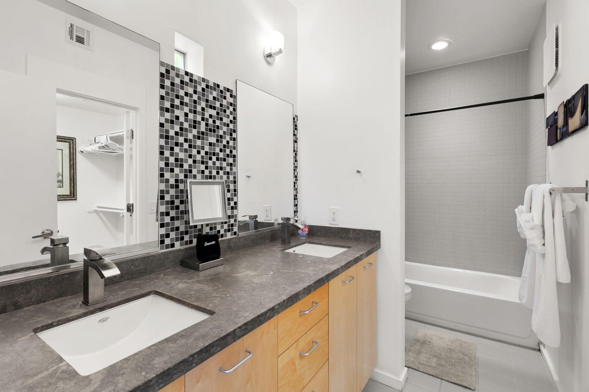 Ensuite bathroom with dual vanity sink and showertub combination.