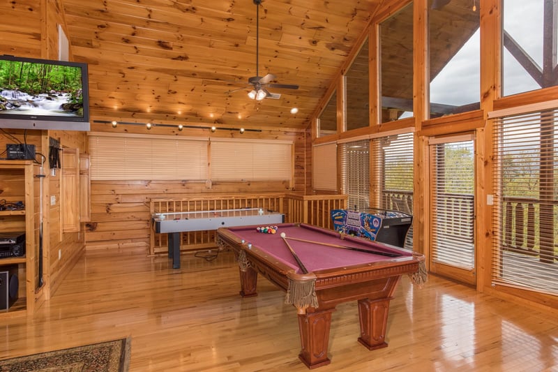 Pool table in the loft space at Howlin in the Smokies, a 2 bedroom cabin rental located in Pigeon Forge