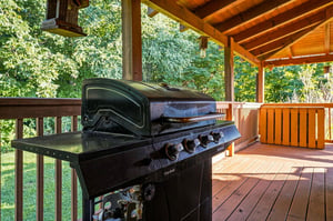 Fire up the grill on your covered deck and savor a meal surrounded by lush forest views and warm natural wood.