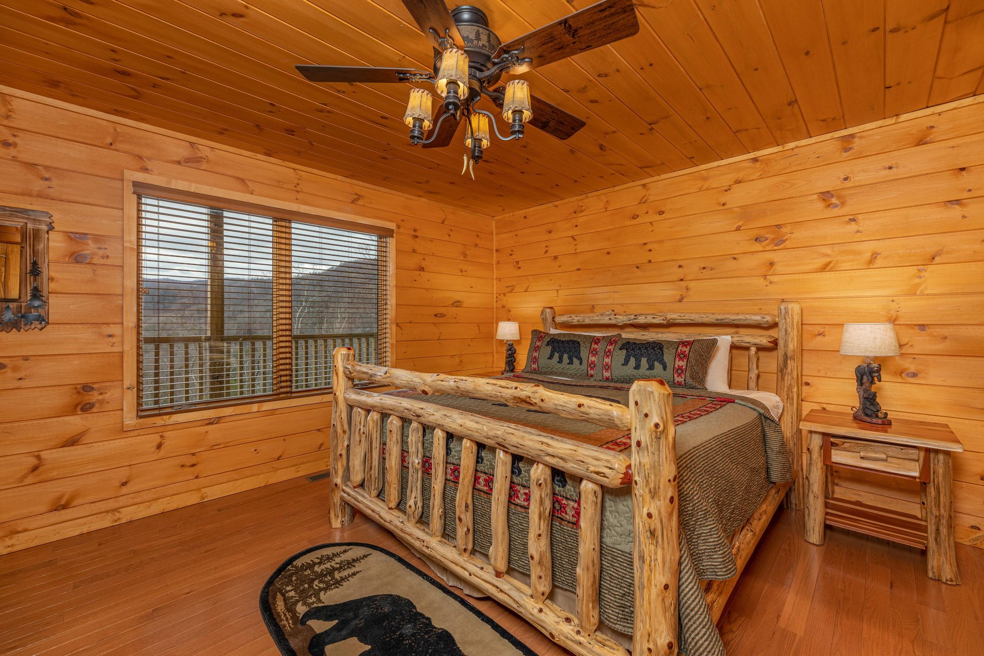 Bedroom with a king bed, night stands, and lamps at Js Hideaway, a 4 bedroom cabin rental located in Pigeon Forge