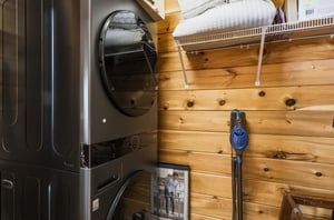 Convenient laundry setup keeps your clothes fresh during your stay. Fullsize washer and dryer with organized storage above.