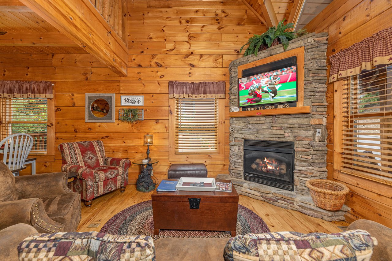Fireplace and TV at Livin Simple, a 2 bedroom cabin rental located in Pigeon Forge