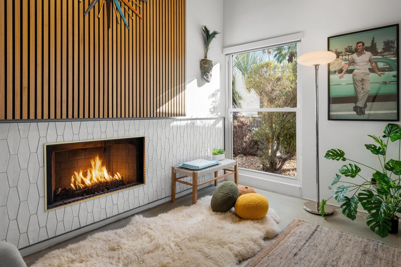 Cozy up by your private fireplace with plush seating and natural light streaming through large windows.
