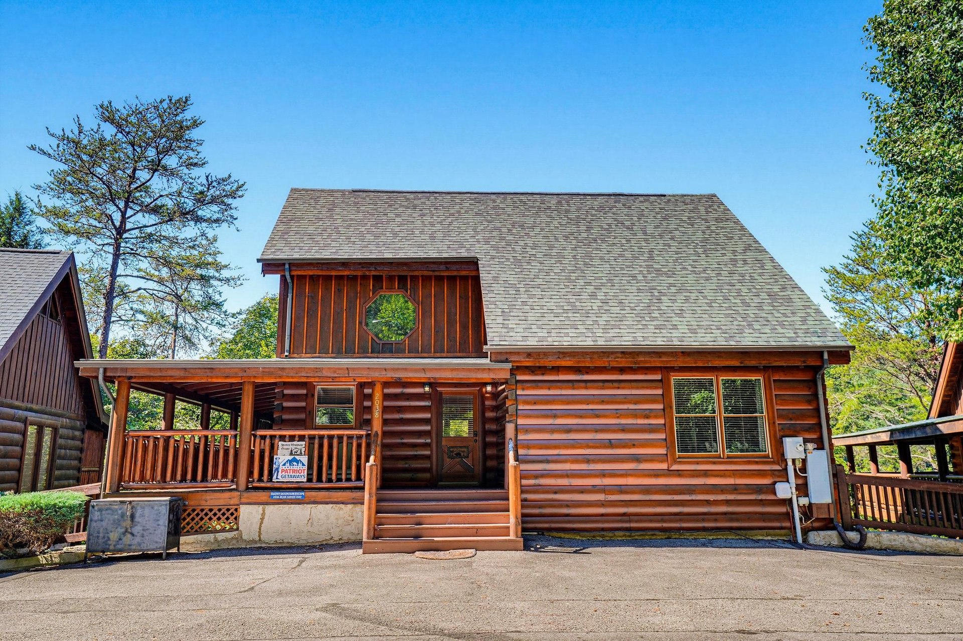 Your private mountain cabin awaits, surrounded by lush trees and offering cozy logstyle charm. Enjoy easy access and a welcoming front porch perfect for morning coffee or evening relaxation.