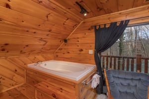 Jacuzzi in the king loft bedroom at Hidden Pleasure, a 1bedroom cabin rental located in Gatlinburg