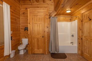 Bathroom with a tub and shower at Bears Dont Bluff, a 3 bedroom cabin rental located in Pigeon Forge