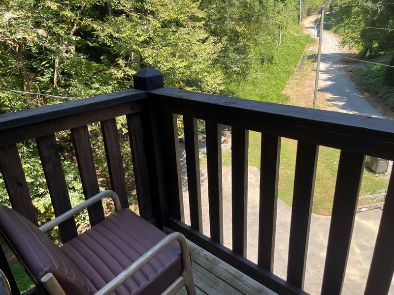The property is nestled in a peaceful natural setting with wooded surroundings and walking paths just outside, offering tranquility and a connection to nature.