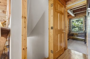 Your cozy cabin features warm wood details and opens to a peaceful covered porch with garden views—perfect for morning coffee or evening relaxation.