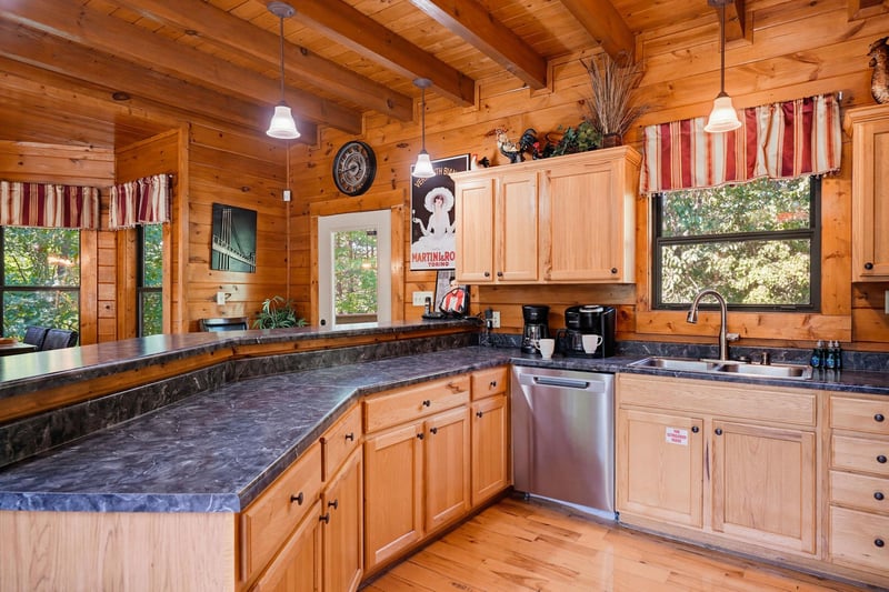 Step into a warm, woodlined kitchen where everything you need is at your fingertips. Sunlight filters through the windows, and the spacious counters invite you to brew coffee or share a meal with lov