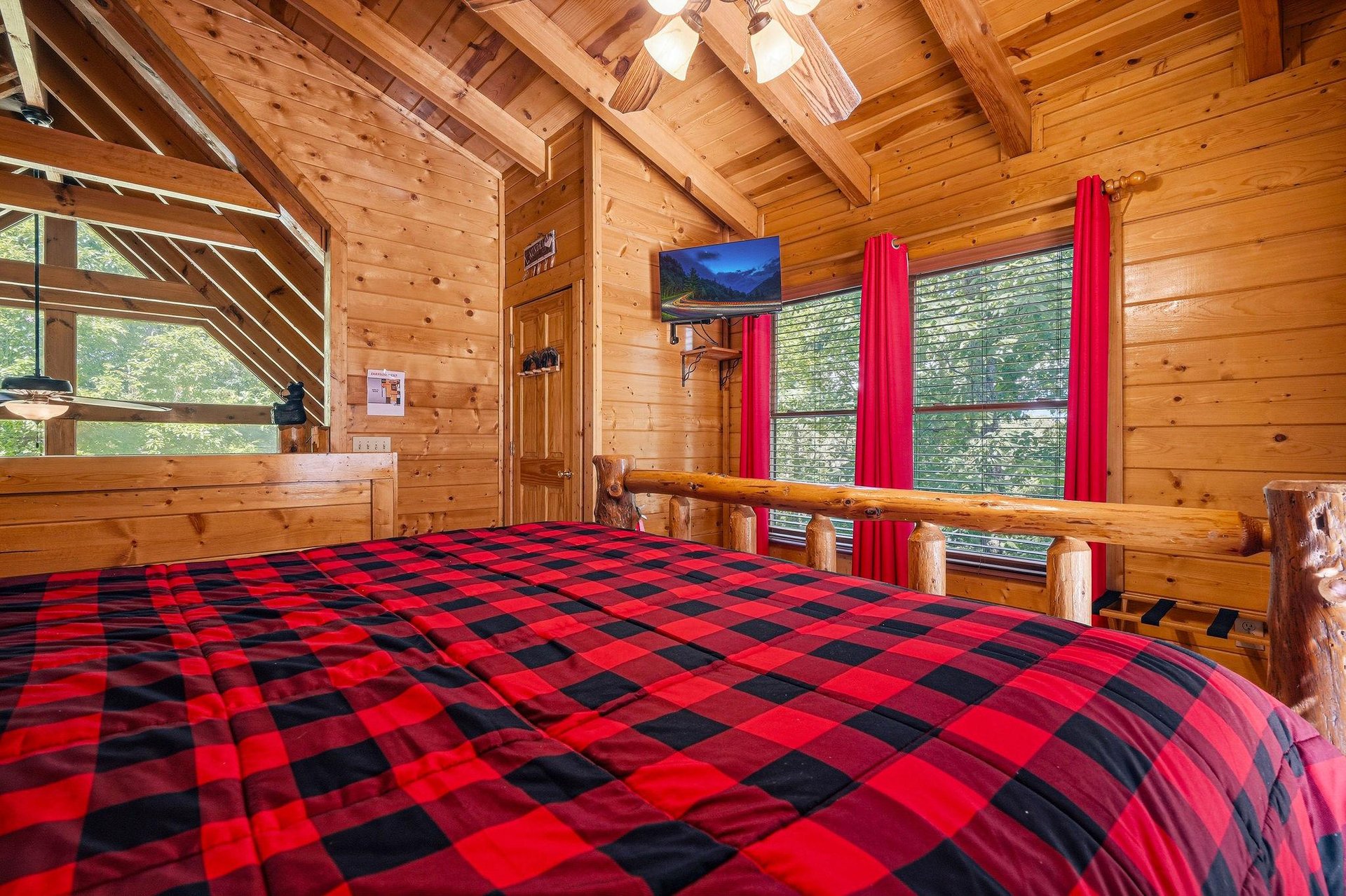 Drift off under vaulted wood ceilings and cozy plaid bedding, with soft natural light streaming in through the windows. Your rustic retreat feels warm, inviting, and perfectly private.