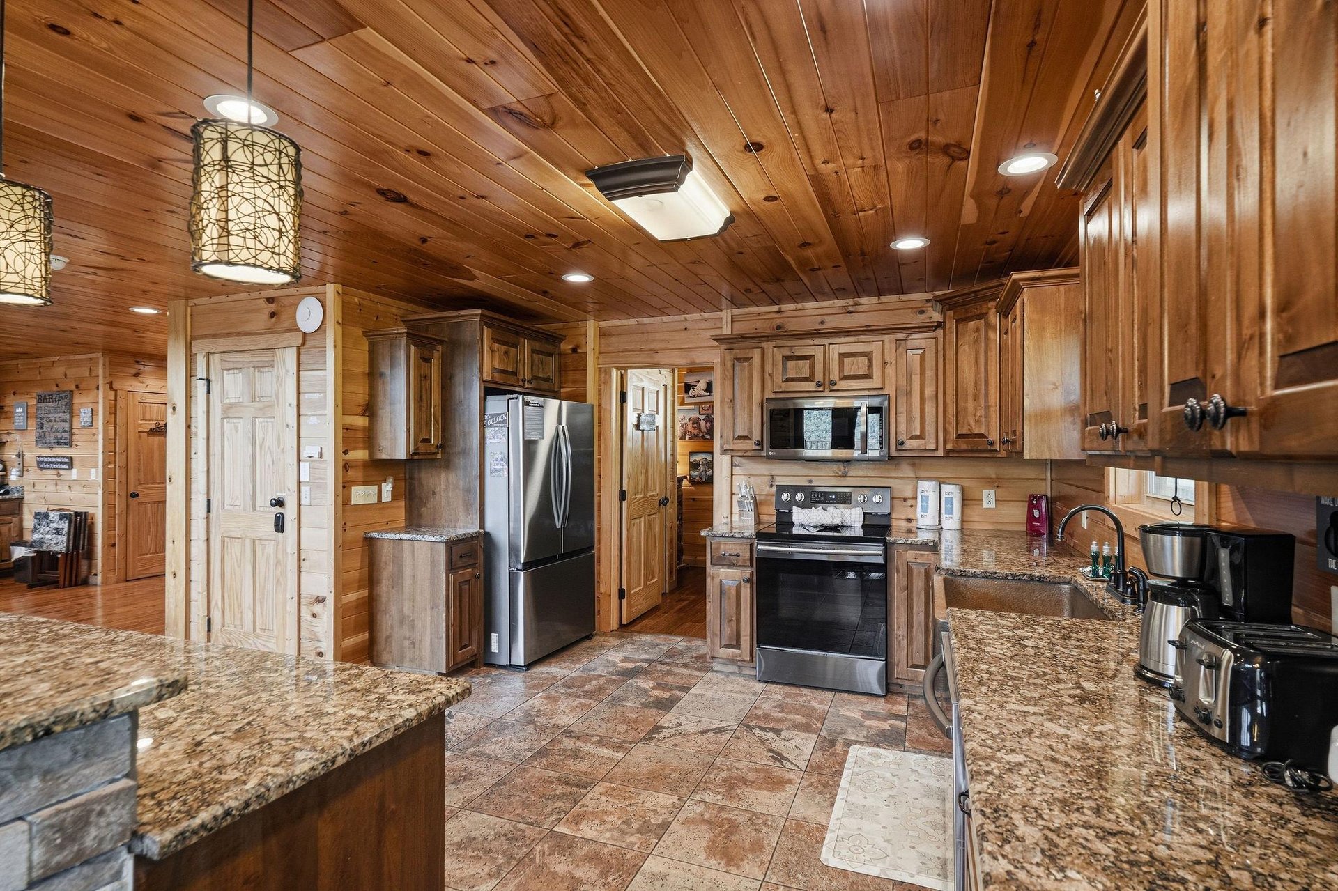 Step into your fully equipped kitchen with granite counters, modern appliances, and warm wood finishes that make meal prep a pleasure during your stay.