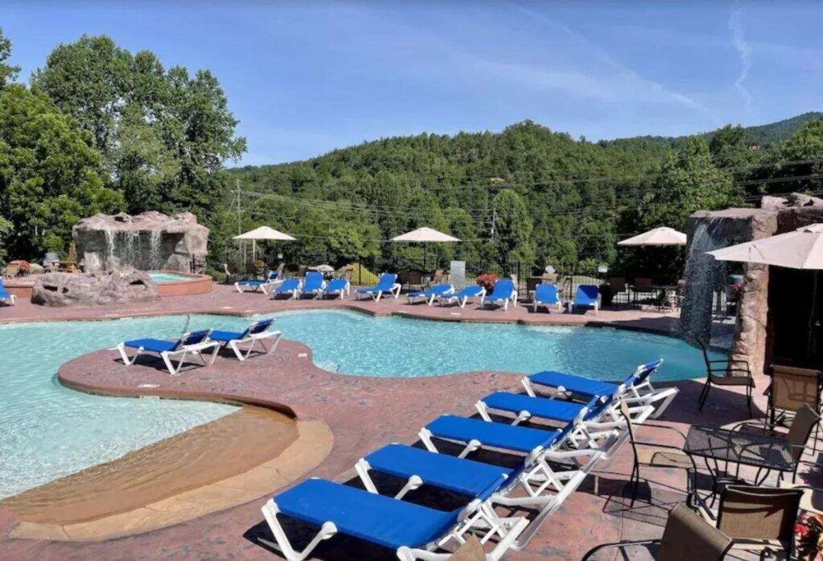 Expansive pool complex with crystalclear water, comfortable loungers, and mountain views creates the perfect outdoor retreat.