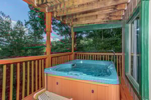 Hot tub on a covered deck at Bushwood Lodge, a 3bedroom cabin rental located in Gatlinburg