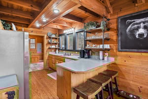 Full kitchen with stools at bar