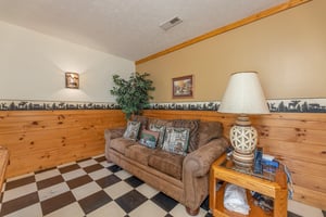 Sofa in the game room at Cubs Crossing, a 3 bedroom cabin rental located in Gatlinburg