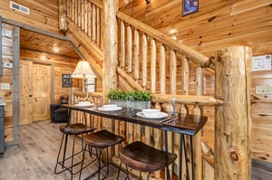 Gather around this rustic dining bar where natural wood and warm lighting create the perfect spot for your mountain meals.