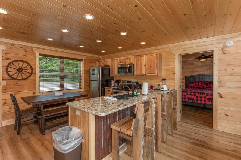 Full kitchen with dining table and chair and benches