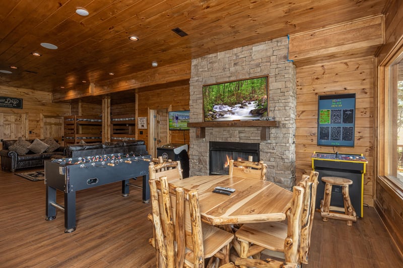 Game room with foosball, arcade game, and poker table