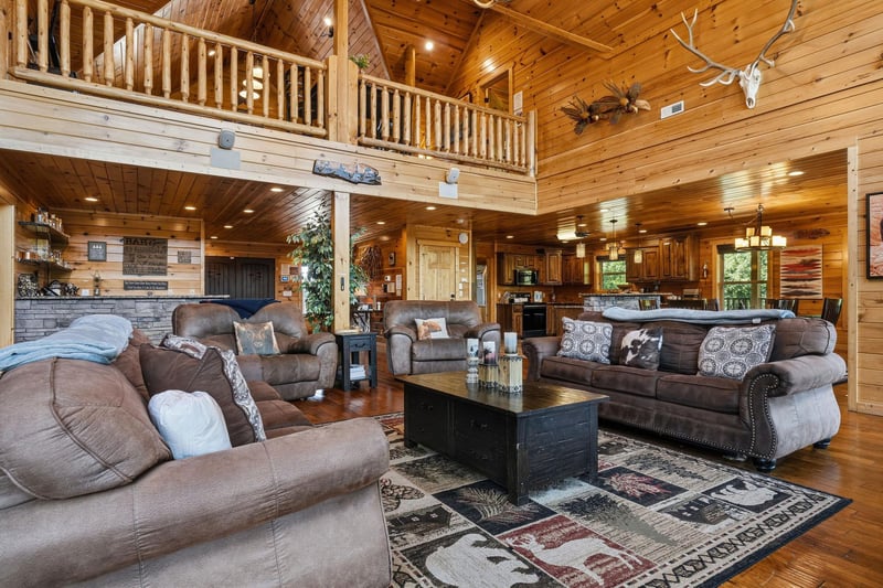 Step into your spacious retreat with vaulted ceilings, rustic wood beams, and plush seating that invites you to unwind. The open layout connects your cozy living area with a full kitchen, perfect for 