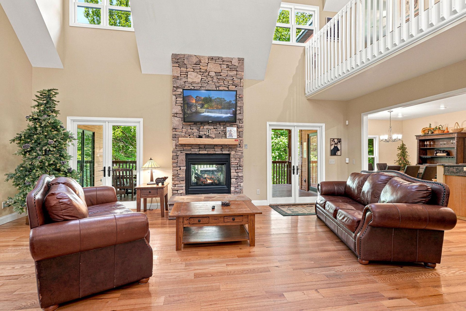 Sink into plush leather sofas by the stone fireplace and enjoy soaring ceilings and sunlight streaming through French doors to your private deck.