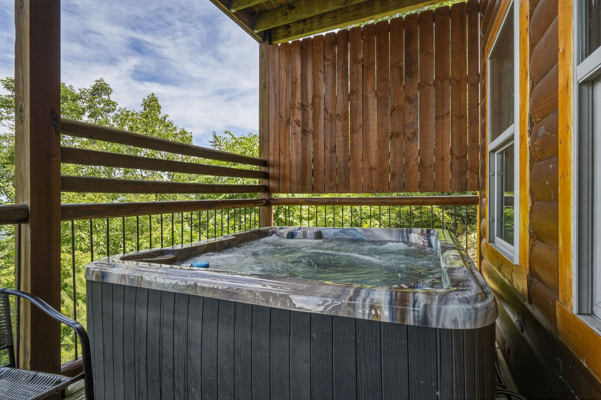 Step into your private hot tub surrounded by lush greenery. Soak away stress while fresh air and natures sounds embrace you on this peaceful covered terrace.
