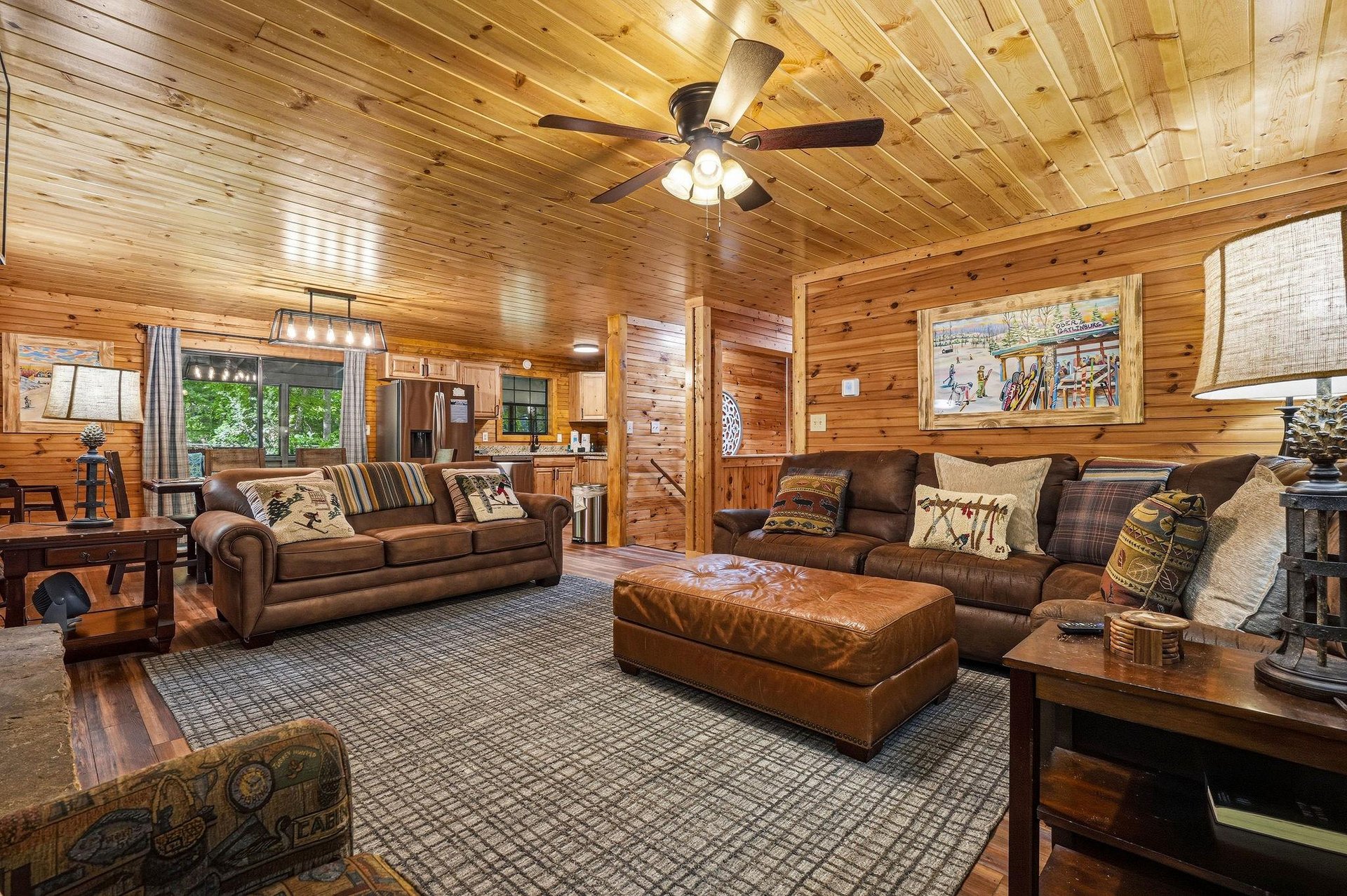 Sink into the rich leather sofas in your cozy living room, where warm wood paneling creates a retreatlike atmosphere perfect for unwinding after your mountain adventures.