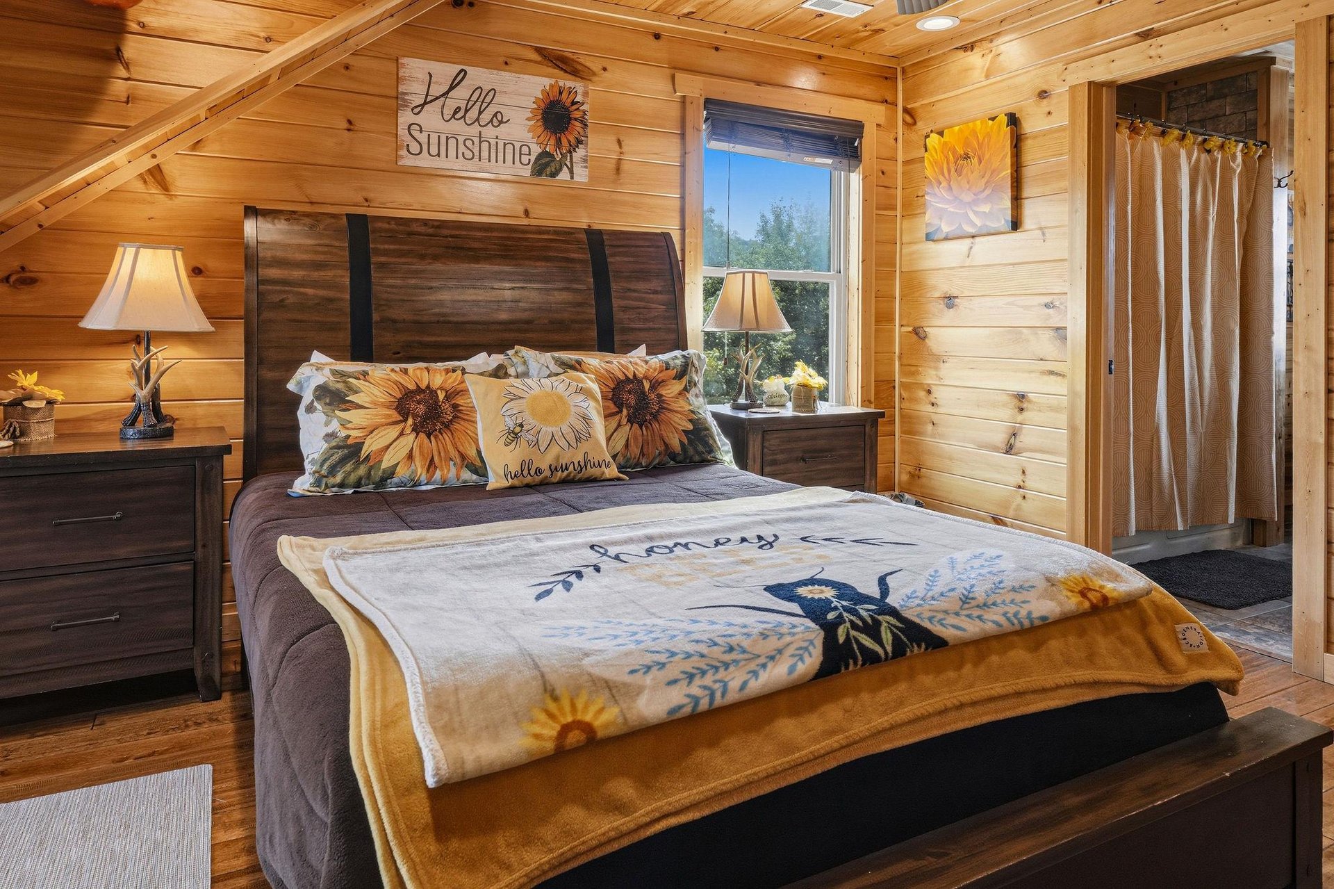 Drift into peaceful sleep in this cozy pine bedroom where sunflowerthemed touches and soft lighting create your cheerful retreat. Wake up to natural light streaming through the window beside your plu