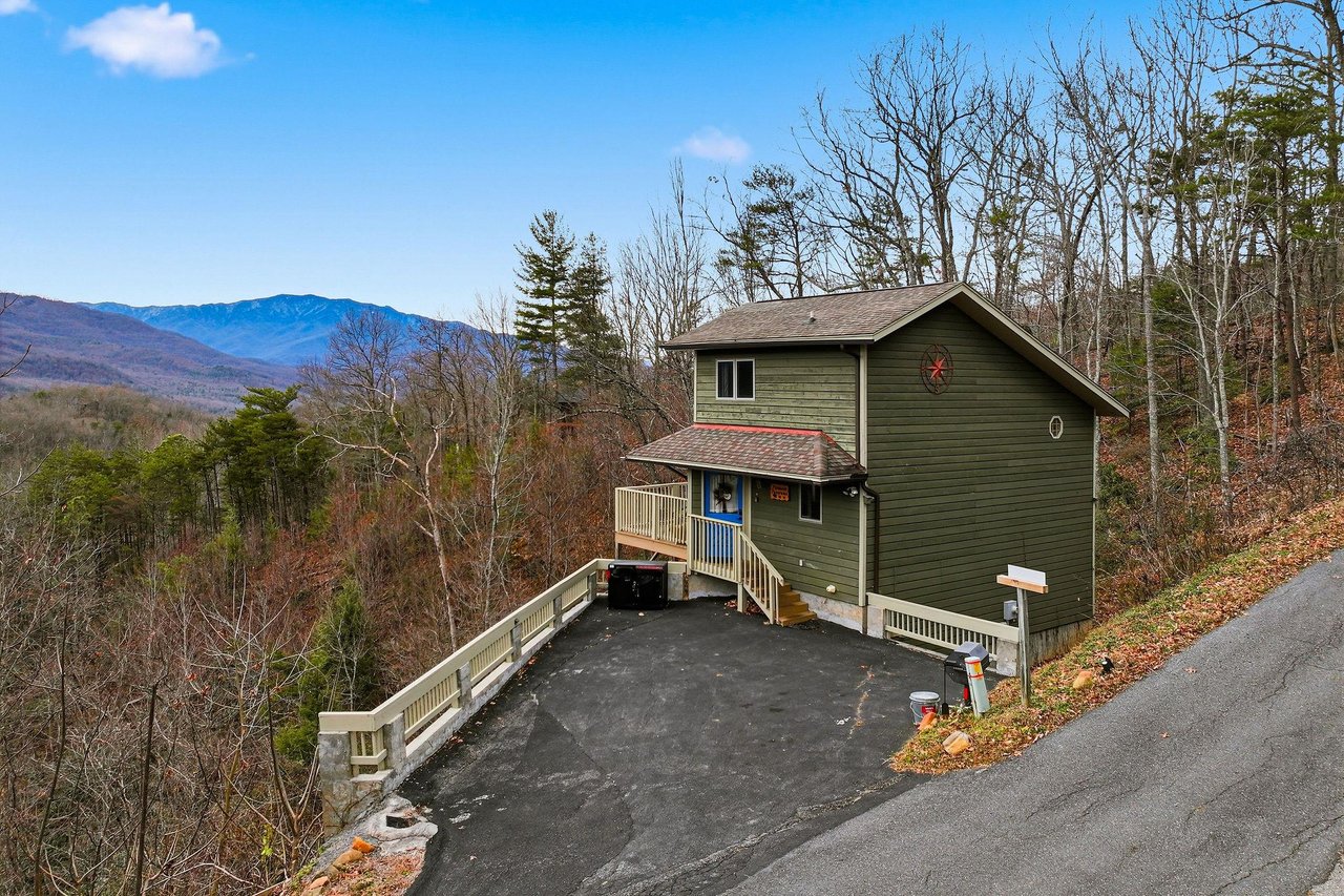 A charming mountain cabin nestled among autumn trees with stunning Blue Ridge vistas and convenient paved access.