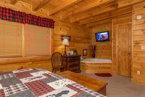 Soaking Tub, TV, and dresser in a bedroom at Absolutely Wonderful, a 2 bedroom cabin rental located in Pigeon Forge