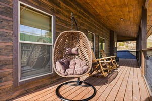 Unwind in your private hanging egg chair on the covered deck, surrounded by warm wood and peaceful views.