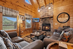 Sink into plush seating around a crackling fireplace beneath soaring woodpaneled ceilings that bring mountain charm into every corner of your retreat.