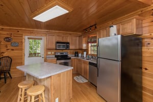 Kitchen with stainless appliances Kick Back  Relax A 4 bedroom cabin rental located in Pigeon Forge