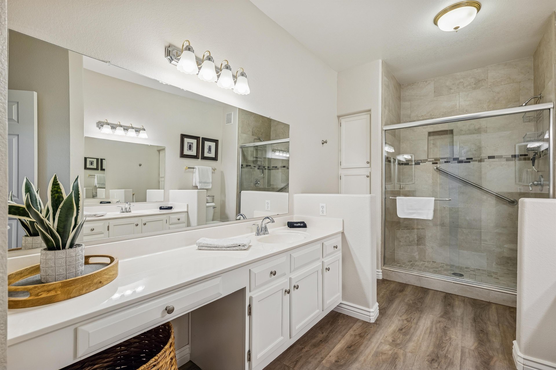 Primary bathroom with walk in shower and dual sinks.
