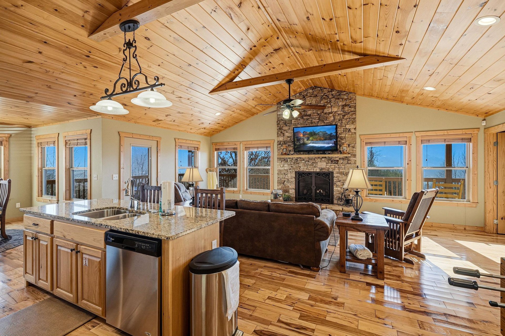 Gather around the stone fireplace or cook together in your spacious open kitchen with granite counters and mountain views.