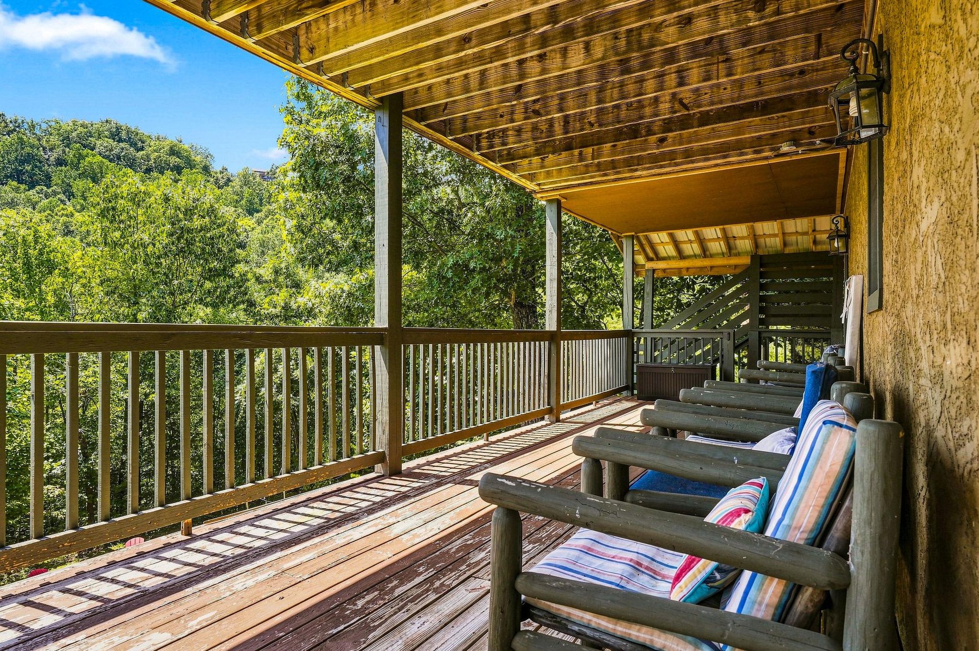 Unwind on your private balcony with colorful cushioned loungers as you take in peaceful treelined views and soak up the natural beauty surrounding you.