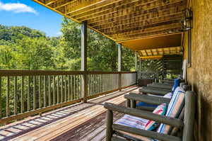 Unwind on your private balcony with colorful cushioned loungers as you take in peaceful treelined views and soak up the natural beauty surrounding you.