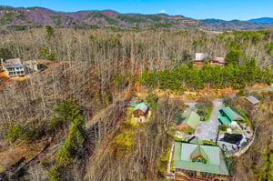 Mountain retreat nestled in rolling hills with forest views and peaceful surroundings.