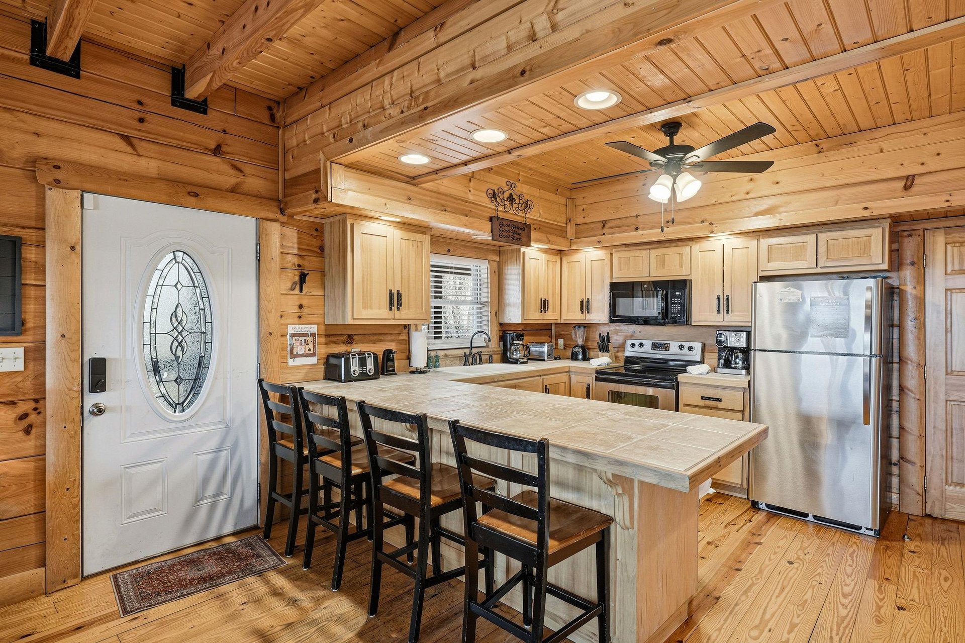 Step into your rustic retreat where warm wood embraces modern convenience—a fully equipped kitchen awaits your culinary adventures.