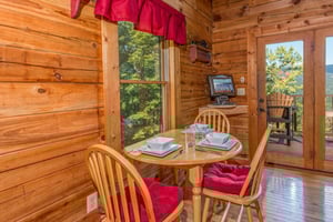 Dining table for three at Cupids Crossing, a 1 bedroom cabin rental located in Pigeon Forge
