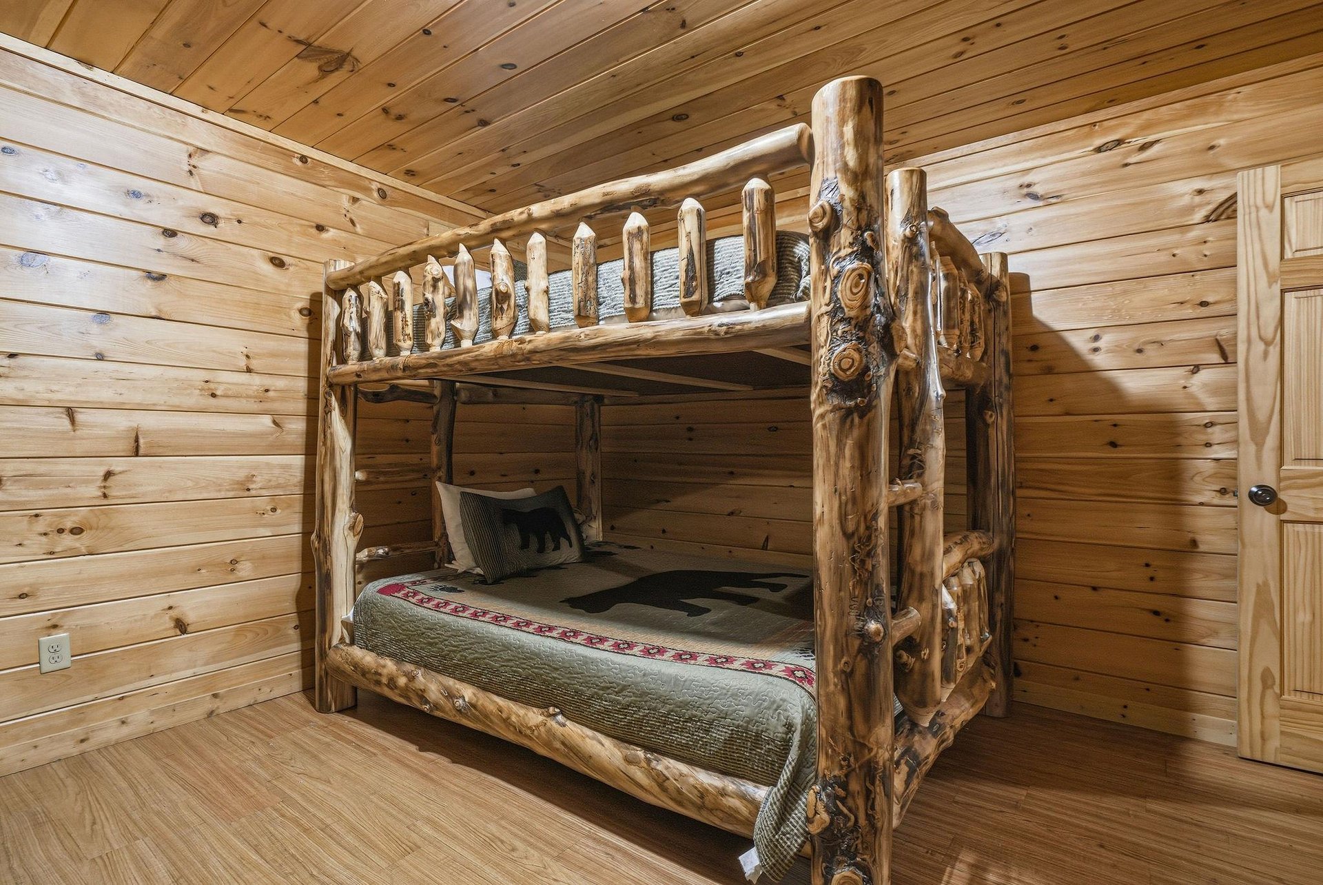 Sleep soundly in this handcrafted log bunk bed, where rustic charm meets cozy comfort in your mountain retreat.