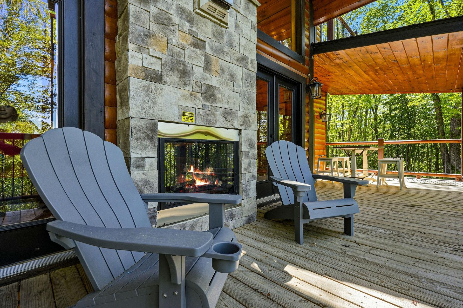 Unwind by your crackling outdoor fireplace on the spacious deck, where Adirondack chairs invite cozy evenings under the trees.