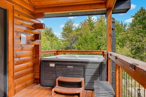 Soak in your private hot tub on the covered deck, surrounded by lush forest views and peaceful mountain air.