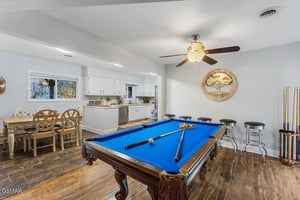 Your perfect entertainment space awaits with a regulation pool table, stylish bar seating, and open kitchen—ideal for memorable gatherings.