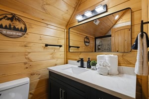Freshen up in your rusticchic bathroom featuring warm wood walls, modern amenities, and thoughtfully arranged towels that make you feel right at home.