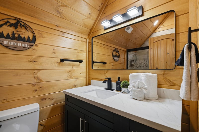 Freshen up in your rusticchic bathroom featuring warm wood walls, modern amenities, and thoughtfully arranged towels that make you feel right at home.