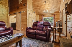 Relax into the warm embrace of your cozy cabin retreat, where rustic wooden walls, plush leather seating, and charming farmhouse touches create the perfect escape from everyday life.