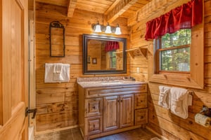 Vanity in the bathroom at Cupids Crossing, a 1 bedroom cabin rental located in Pigeon Forge