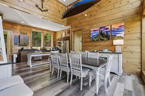 Gather around this beautiful dining table in your rusticchic cabin. The warm wood walls and mountain artwork create the perfect backdrop for memorable meals.