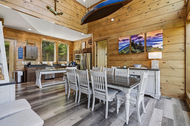 Gather around this beautiful dining table in your rusticchic cabin. The warm wood walls and mountain artwork create the perfect backdrop for memorable meals.